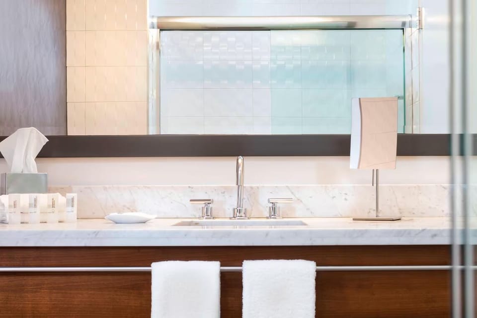 Refresh at the sleek marble vanity with bright, flattering light.