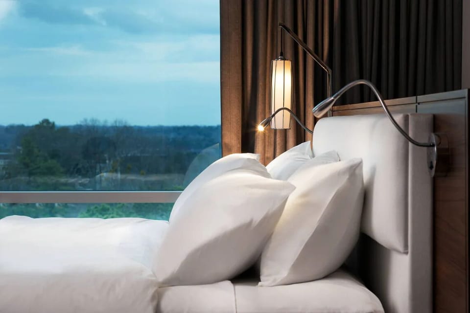 Wake gently to serene views framed by soft, layered bedding.