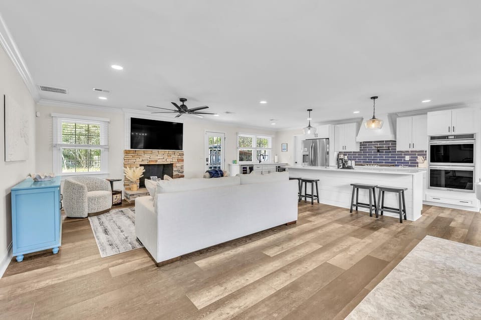 Large open concept highlighting crisp interiors and calming ocean inspired tones