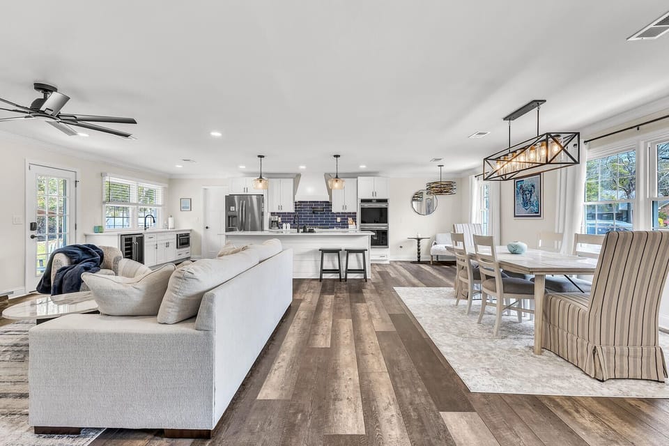 Sunlight pours through oversized windows, highlighting crisp interiors.