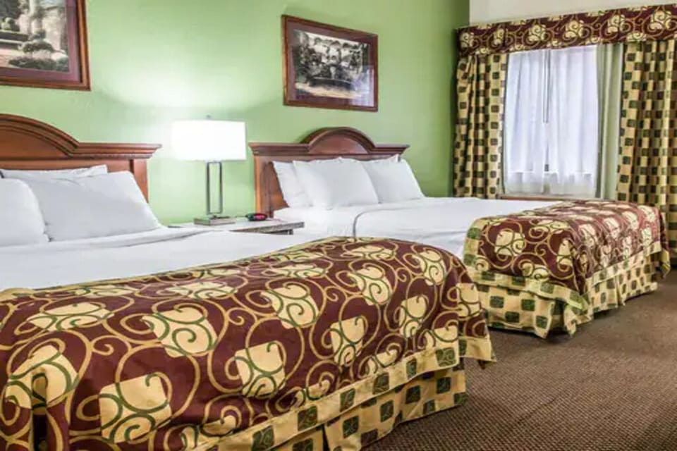 Unwind in a bright double-queen room with cozy linens.