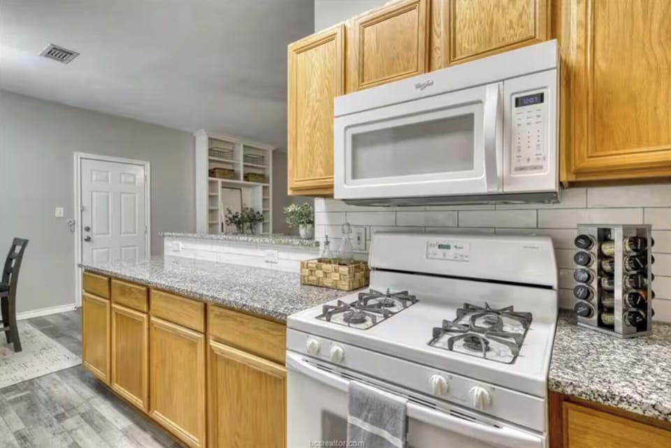 Gas cooktop and microwave, along with pots and pans and basic spices 