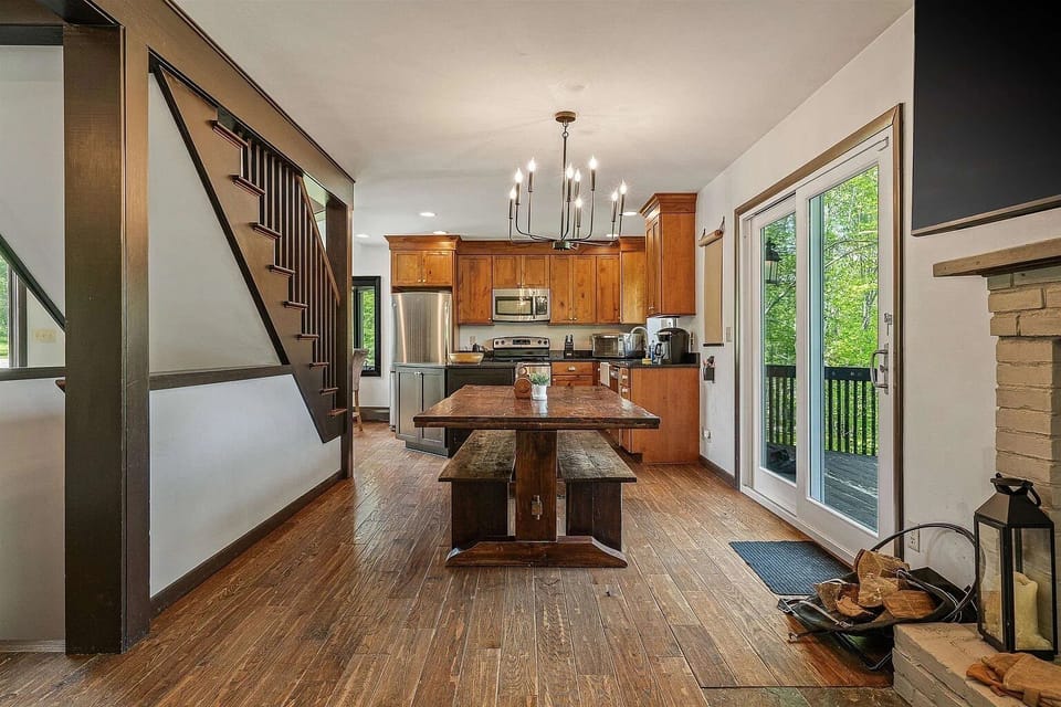 Fully stocked kitchen and dining table with sliding door to deck