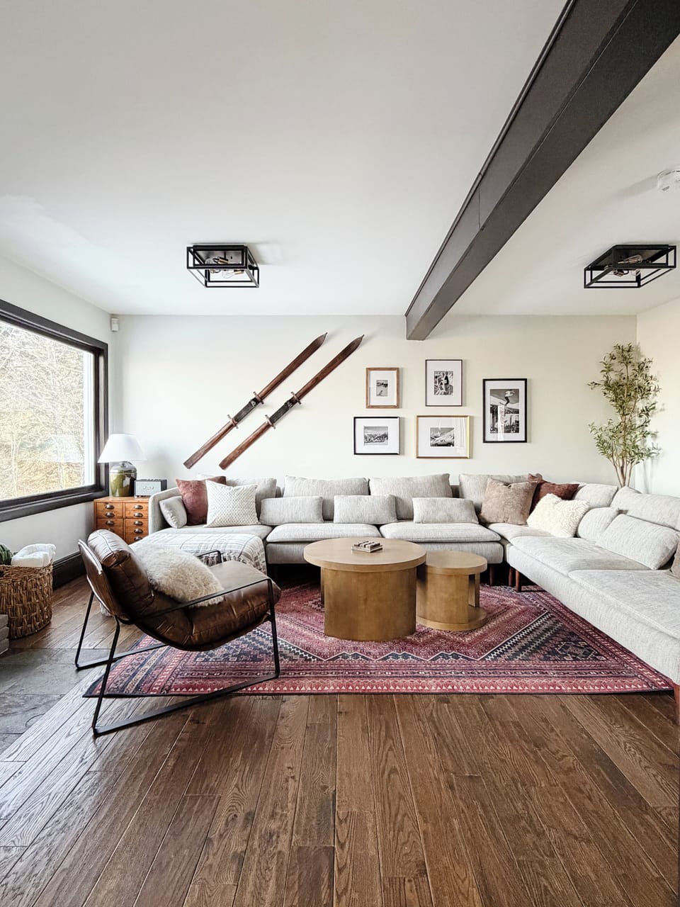 Living room with ample seating, fireplace, and 75" TV