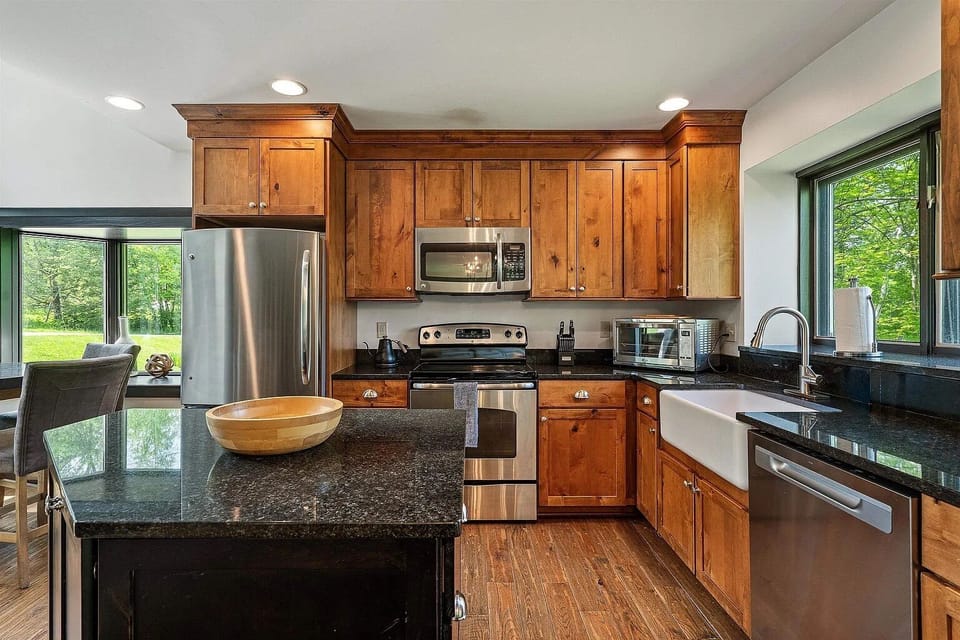 Fully stocked kitchen and dining table with sliding door to deck