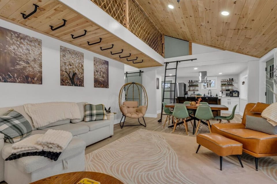 The loft ladder is just sitting there whispering climb me while the space pulls off calm luxury without trying.