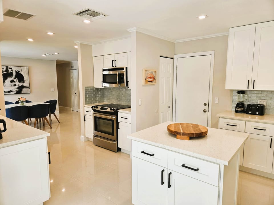 Kitchen has Fridge, Oven, Microwave, Dishwasher and Coffee Maker