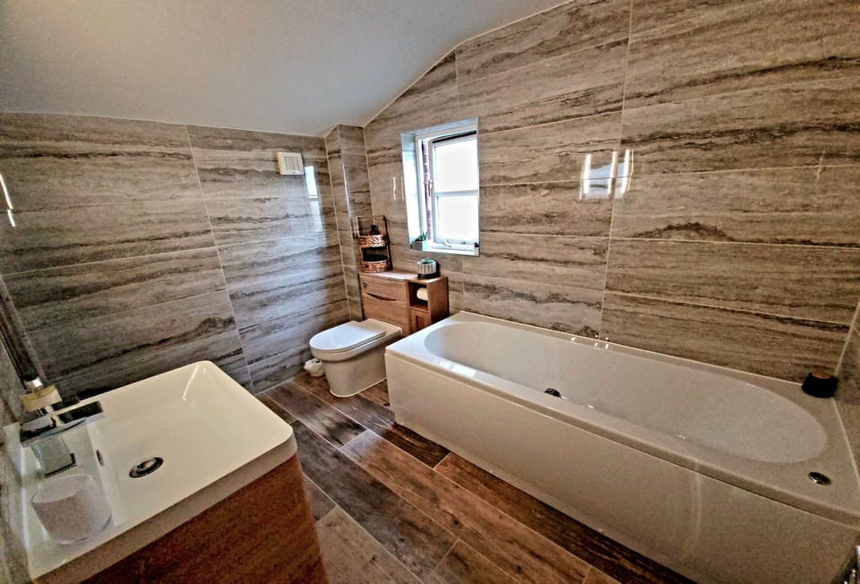 Langunnett Cottage, Looe. First Floor: En-suite bathroom with a bath, separate shower, wash basin and WC
