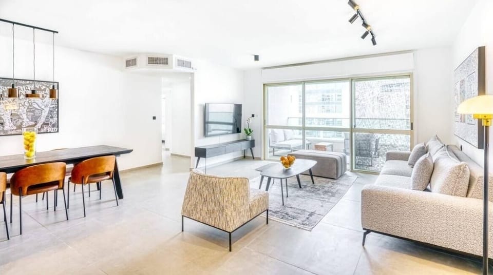 Bright, open-concept living room and kitchen designed for comfort and gathering.