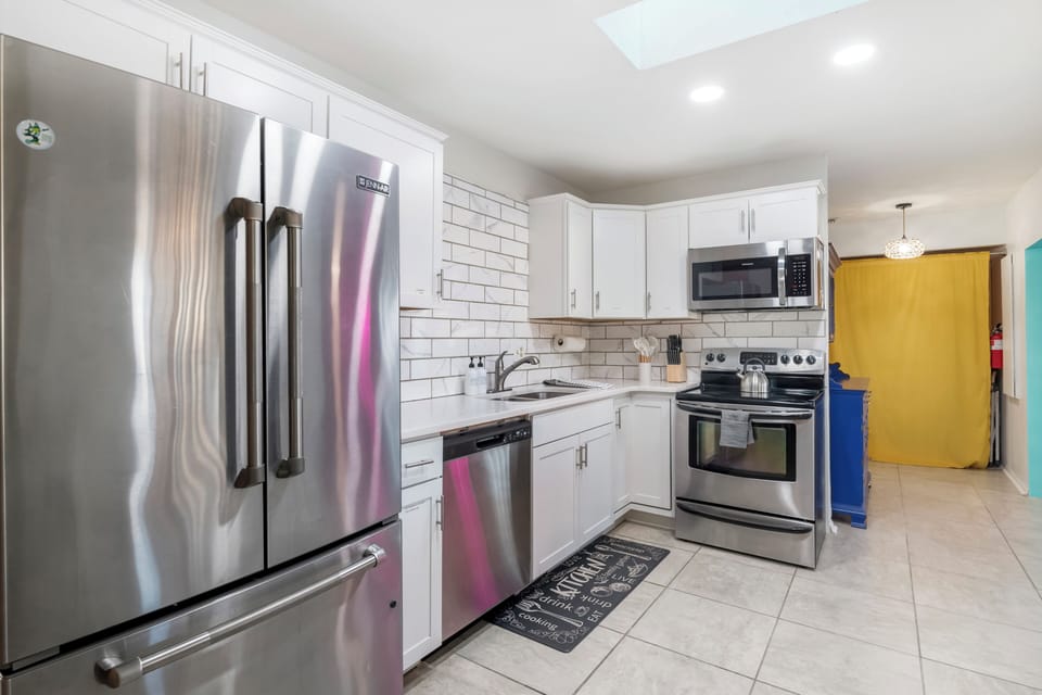 Step into your bright, modern kitchen—fully stocked and ready for your getaway! 
