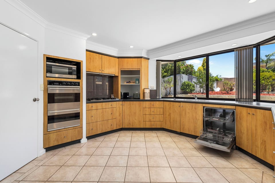 Large fully equipped kitchen for cooking a meal in with 2 ovens, sink, gas stove, dishwasher and starter amenities.