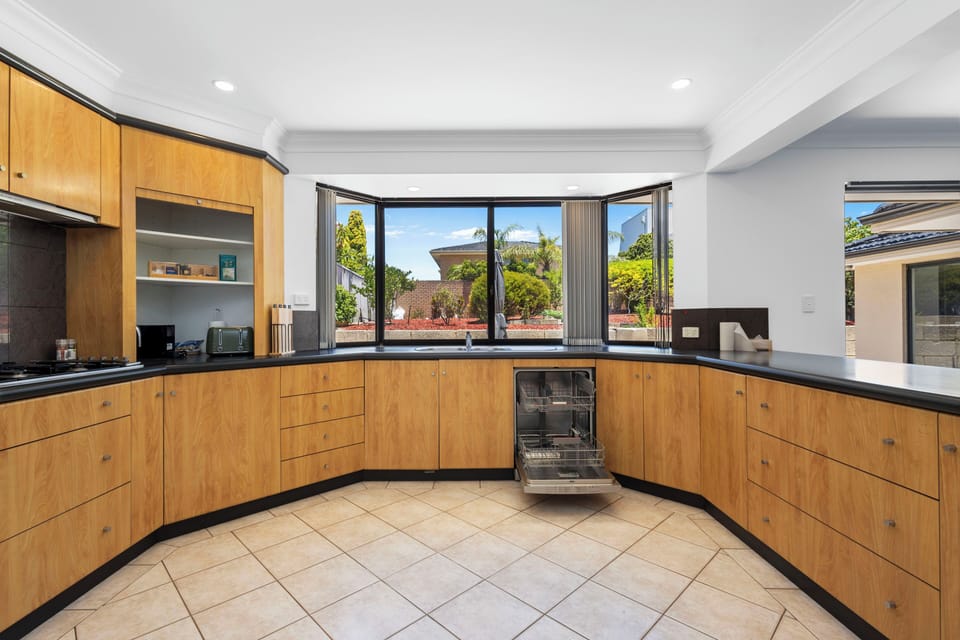Large fully equipped kitchen for cooking a meal in with 2 ovens, sink, gas stove, dishwasher and starter amenities.