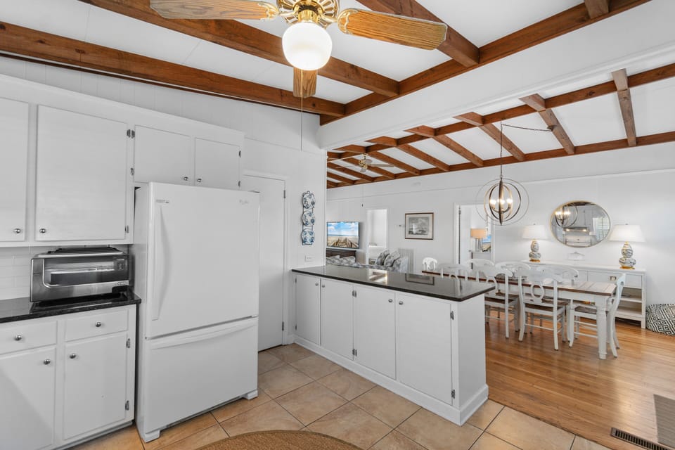 Cook memorable meals in this spacious kitchen with exposed beams, granite counters, and modern appliances flowing into your elegant dining space.