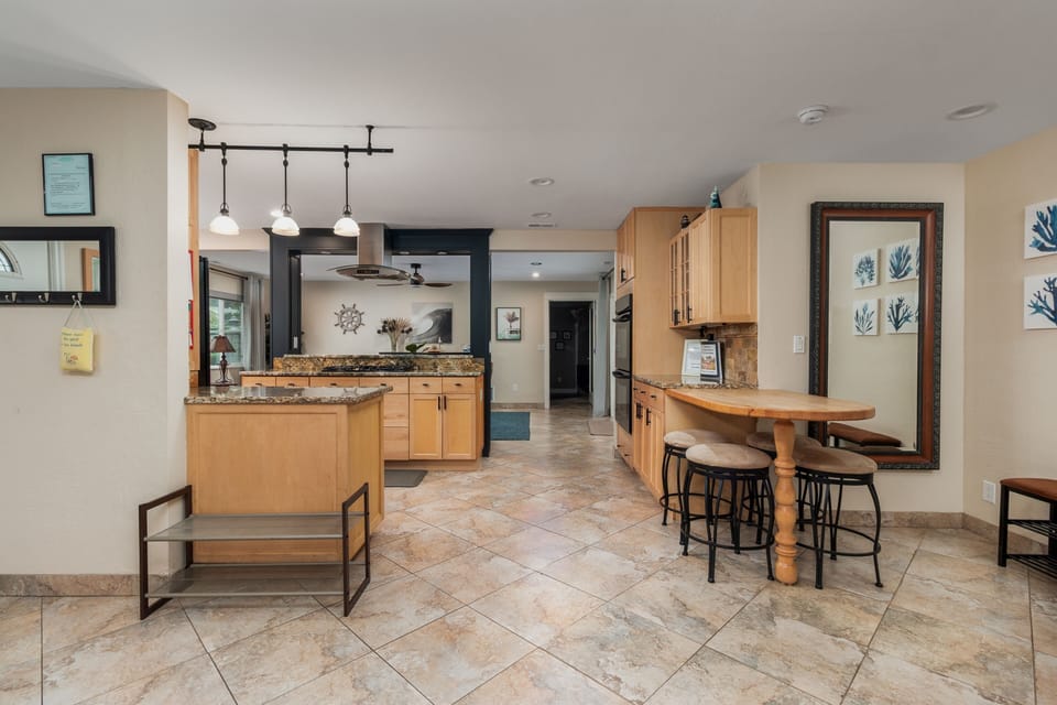 Your spacious kitchen invites culinary adventures with granite counters, modern appliances, and a charming breakfast bar perfect for morning coffee.