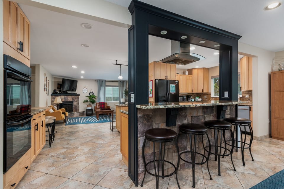 Your open kitchen flows seamlessly into the living space, featuring granite counters and bar seating perfect for morning coffee or evening wine.