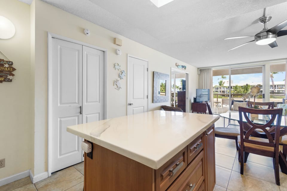 Your spacious kitchen island flows seamlessly into the dining area, where you'll enjoy meals with tropical views.