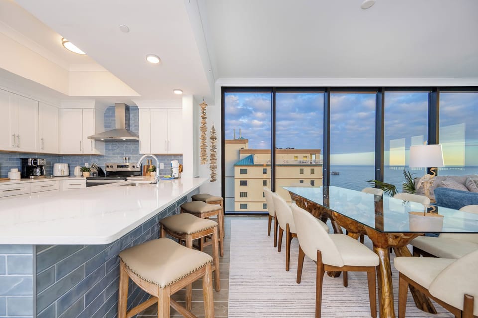 Enjoy meals at the elegant dining table while admiring the serene beach views