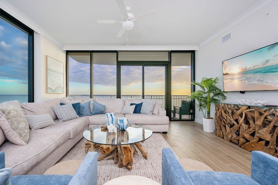 Relax on the spacious sectional sofa while enjoying the stunning beachfront view from the balcony