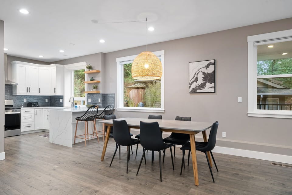 Your stylish dining space flows seamlessly into the modern kitchen, creating the perfect spot for memorable meals together.