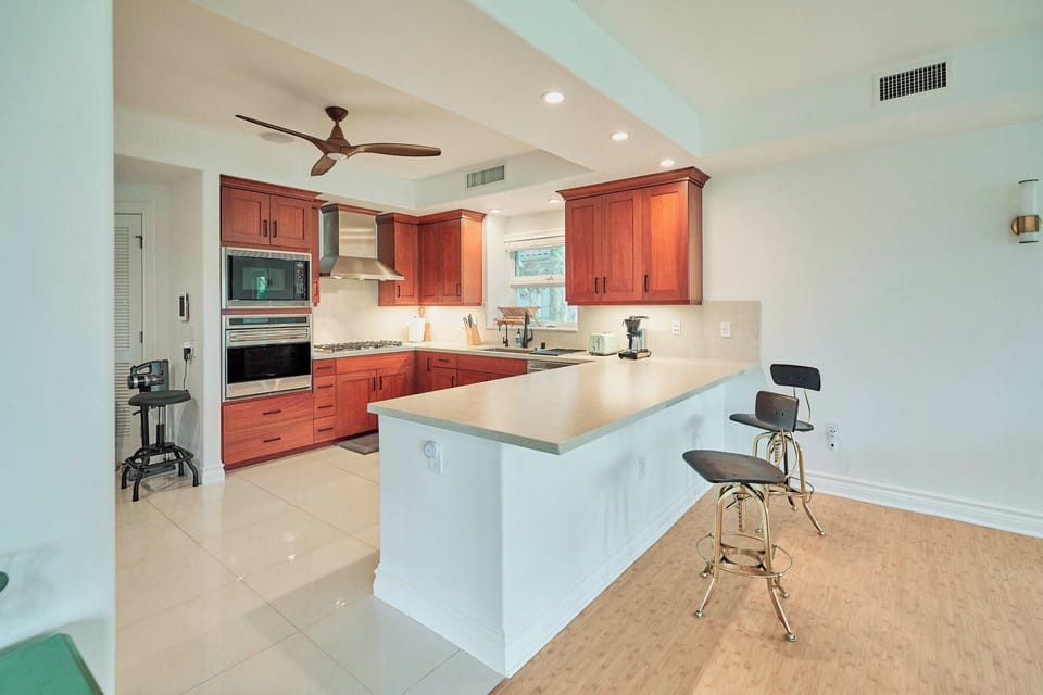 Your spacious kitchen features warm wood cabinets, granite counters, and a breakfast bar where you'll love starting your mornings with coffee.