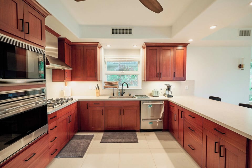 Your spacious kitchen features warm wood cabinets, marble countertops, and professional-grade appliances—perfect for creating memorable meals together.