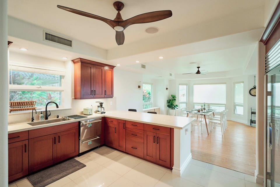 Your spacious kitchen features rich wood cabinets, granite counters, and stainless appliances—perfect for preparing memorable meals during your stay.