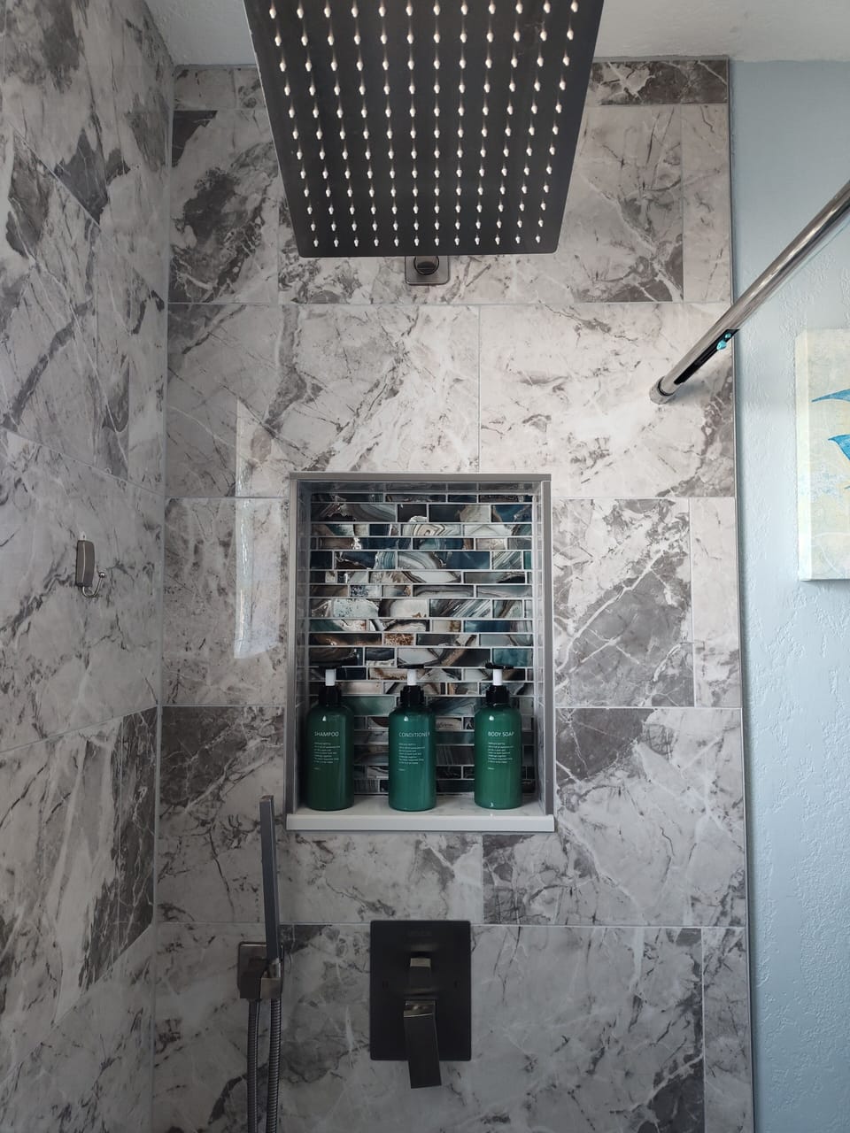 Remodeled shower with 12" x 12" shower. Shampoo, conditioner and body wash