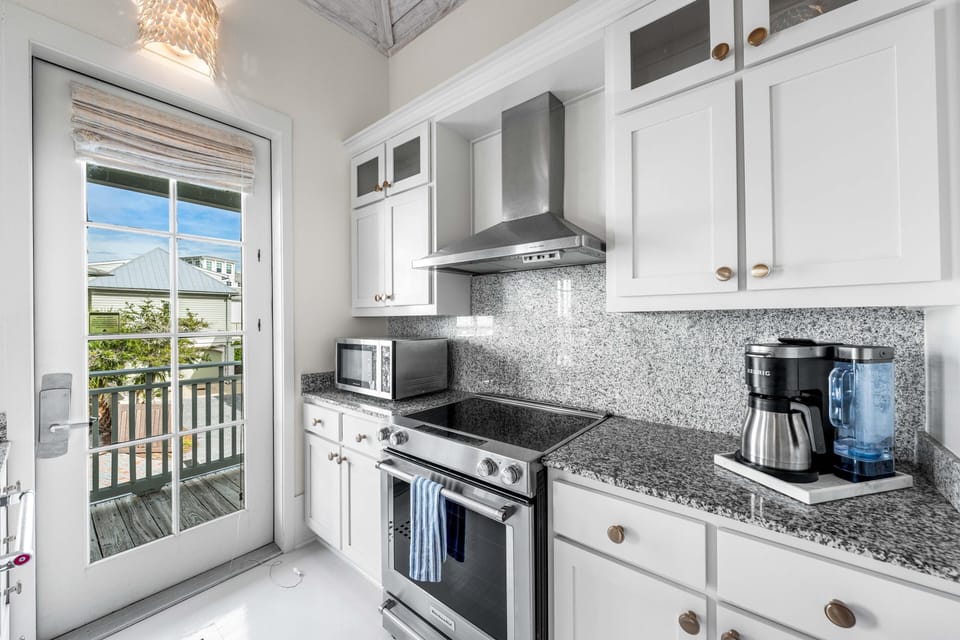 Your bright, fully-equipped kitchen features granite countertops and stainless appliances, perfect for preparing meals during your stay.