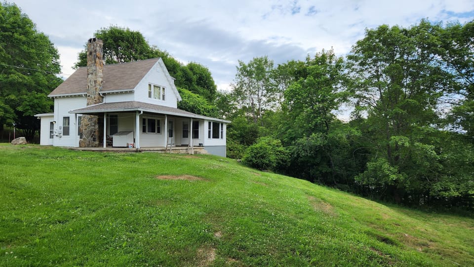 Light landscaping, porch rocking chairs & outdoor seating w/firepit added spring