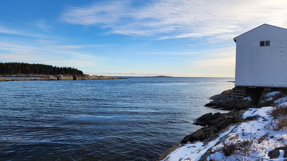 Winter at property's waterfront out towards Casco Bay, old fishing pier building