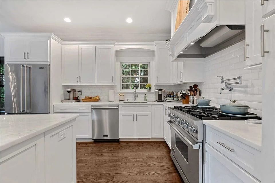 Viking 6-burner range and hood anchor a kitchen built for serious cooking.