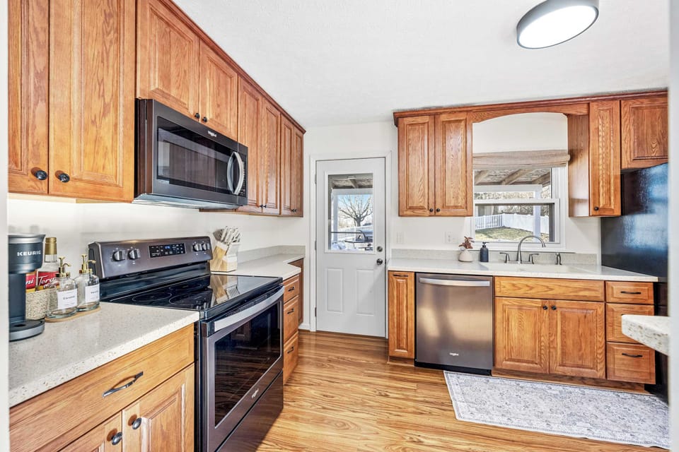 Fully equipped kitchen w/ ample counter space & wood cabinetry
