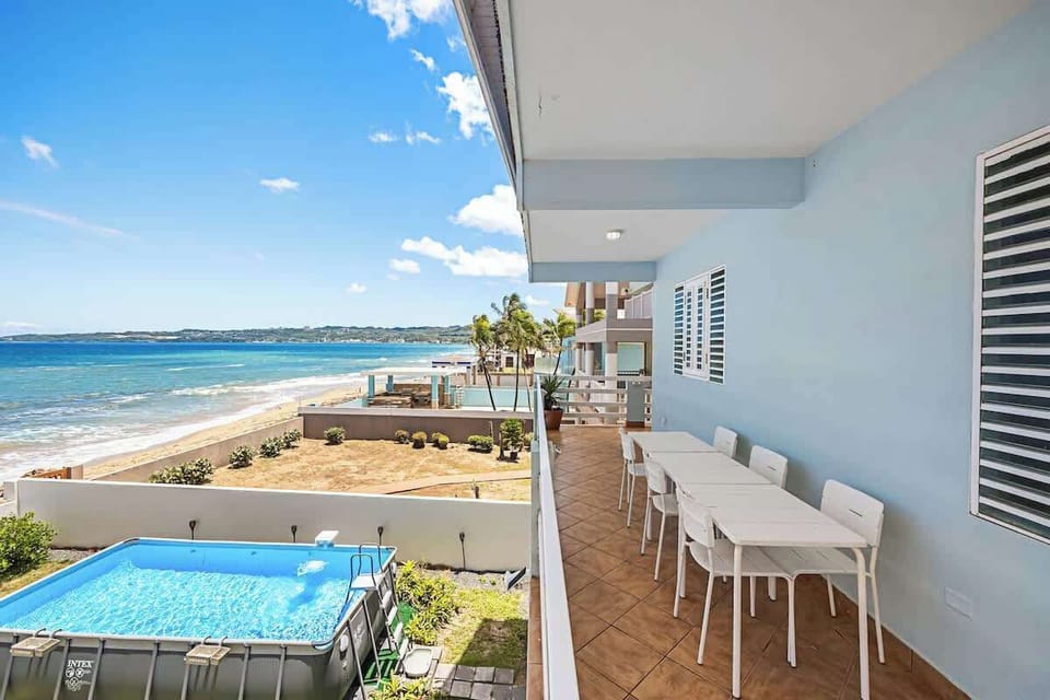 Enjoy a meal with a pool and ocean view.