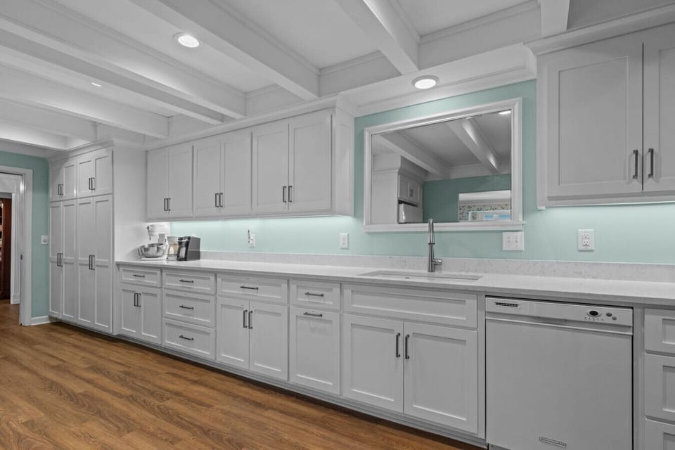 Spacious coastal kitchen with long countertops, abundant storage, and modern appliances
