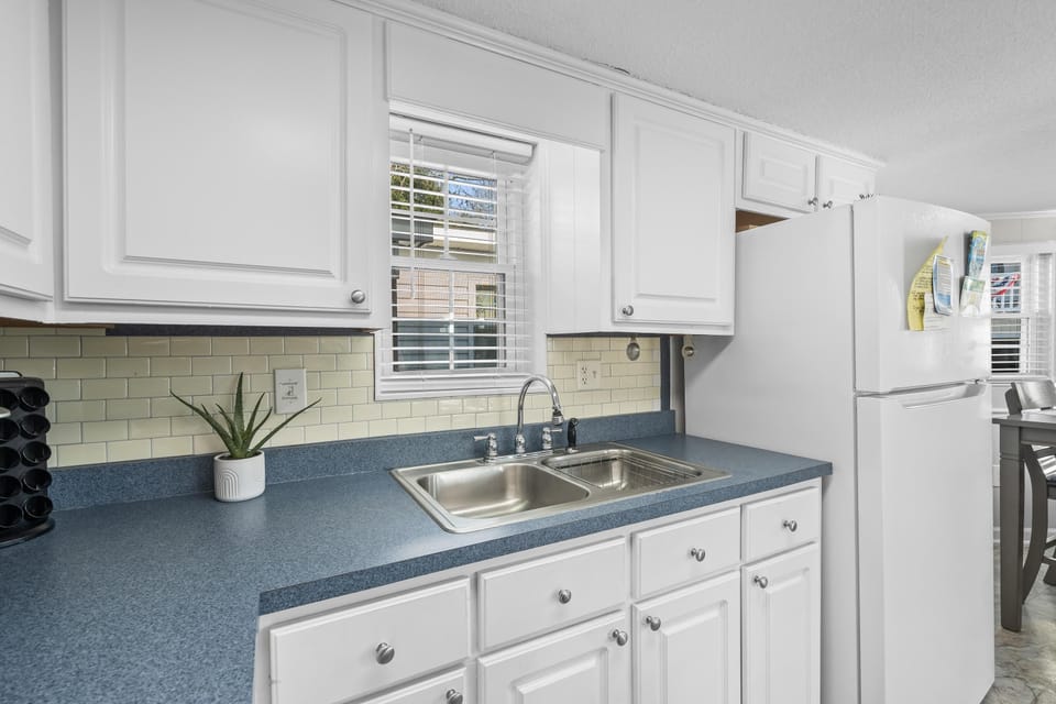 Bright kitchen with classic white cabinetry and cozy window light