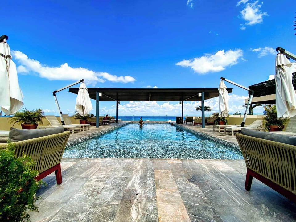Rooftop pool with outdoor furniture 