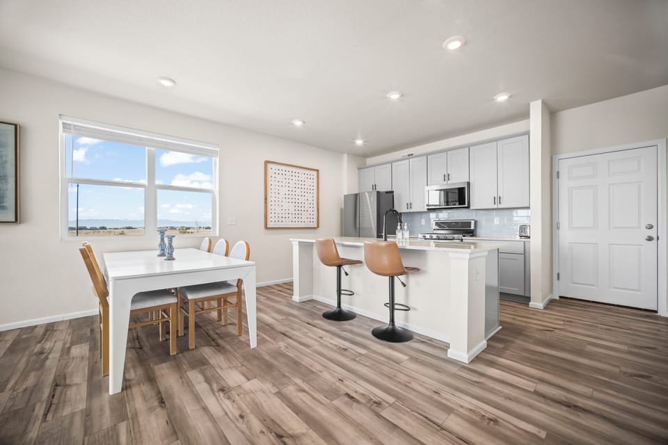 Clean, contemporary kitchen with comfortable dining space and plenty of natural light.