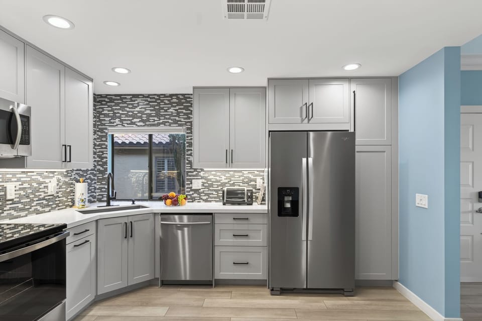 Kitchen features stainless steel appliances.