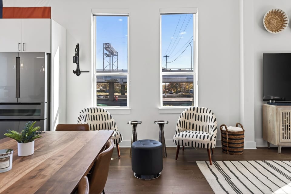 Cozy dining or sitting nook featuring patterned accent chairs and large windows.