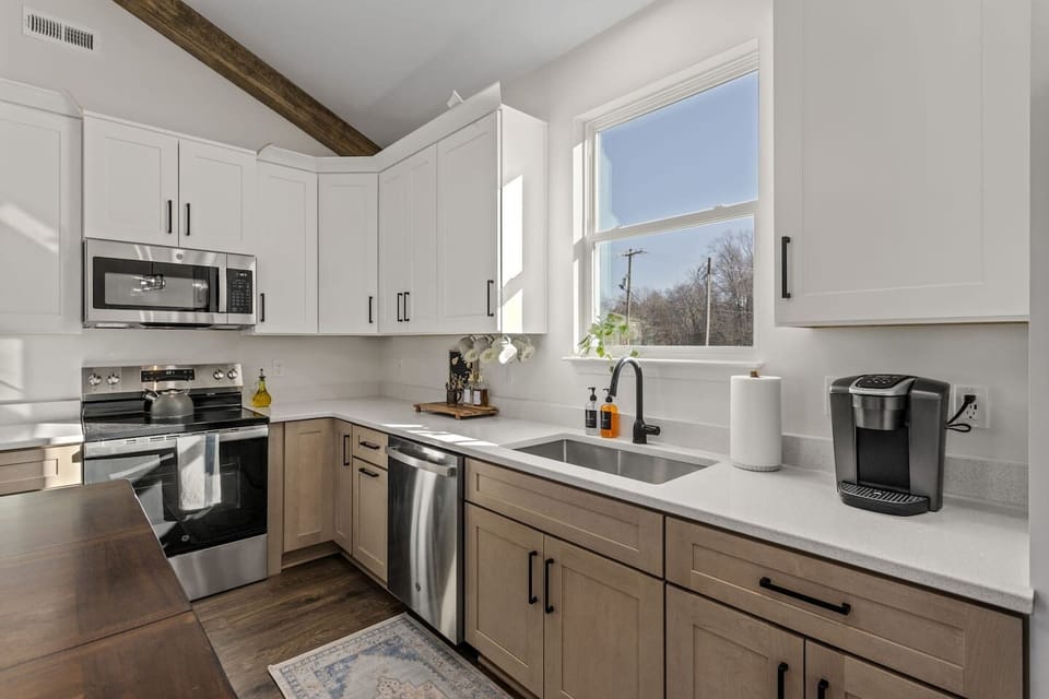 Our kitchen, fully stocked with enough cookware and dishes to cook in and host.
