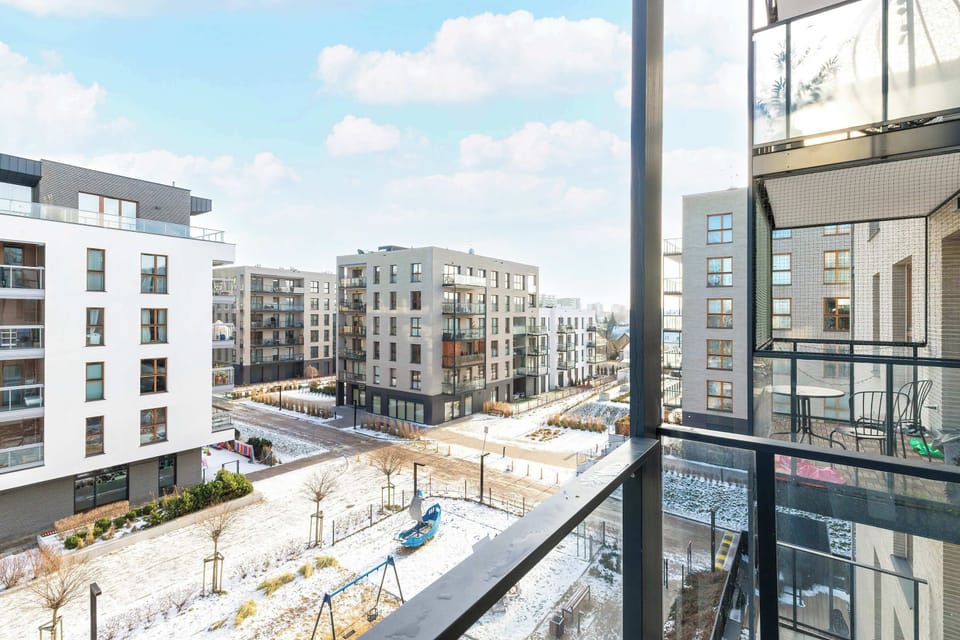Scenic balcony view overlooking modern apartment buildings and the street below.