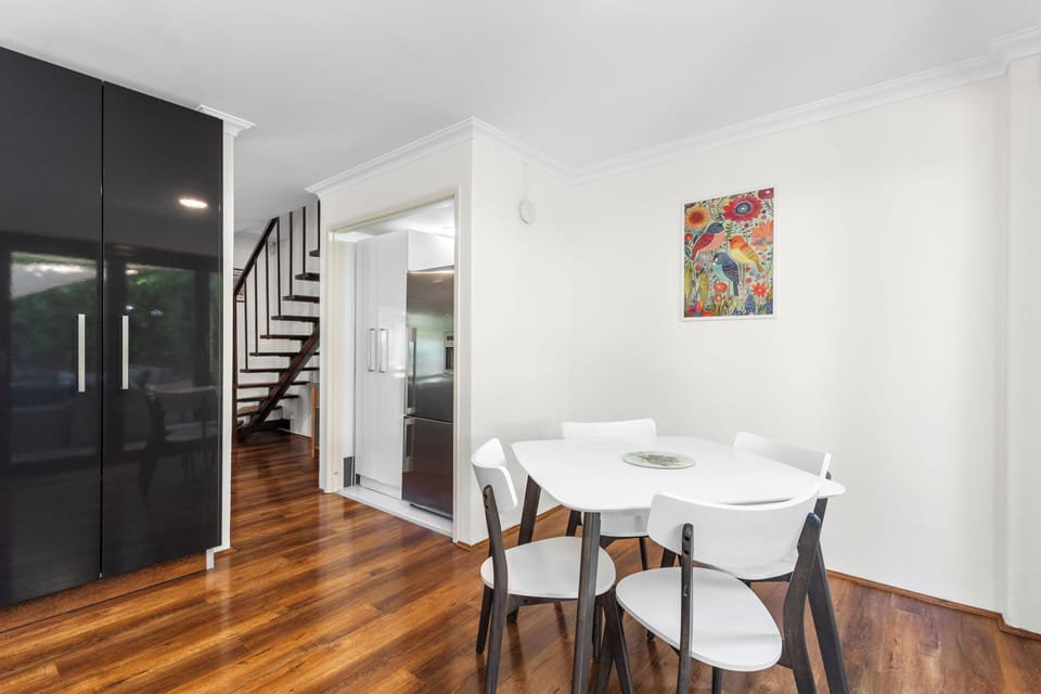 Bright, contemporary dining space featuring a 4-seat table with elegant white accents.