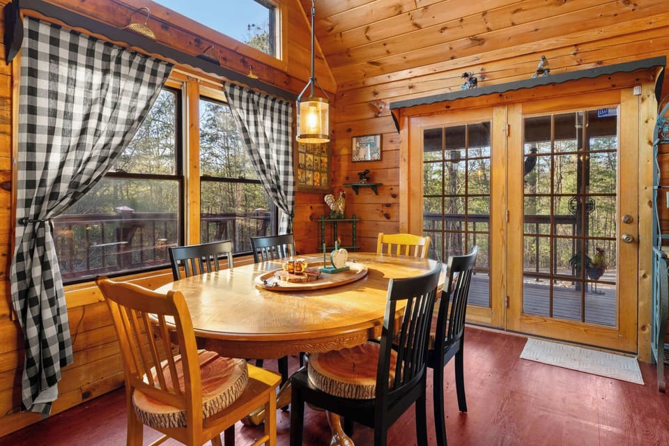 Sun-drenched dining area with forest views and rustic seating for memorable family meals.