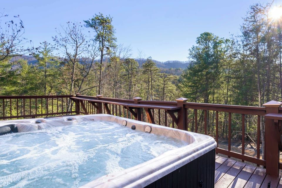 Relax in the private porch hot tub while soaking in breathtaking mountain and forest views.