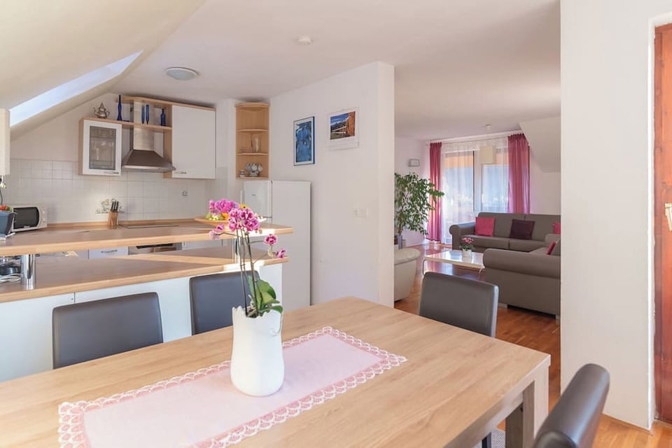 Kitchen with a dinning area and large living room in the background.
