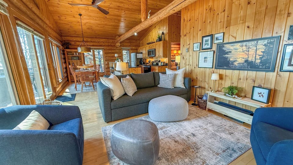 Sink into plush sofas surrounded by warm wood walls and beams. Your cozy retreat features an open layout perfect for gathering with loved ones.