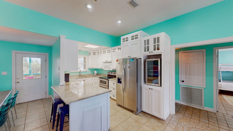 The heart of your beach house stay — an open kitchen and dining area perfect for shared meals and seaside memories.