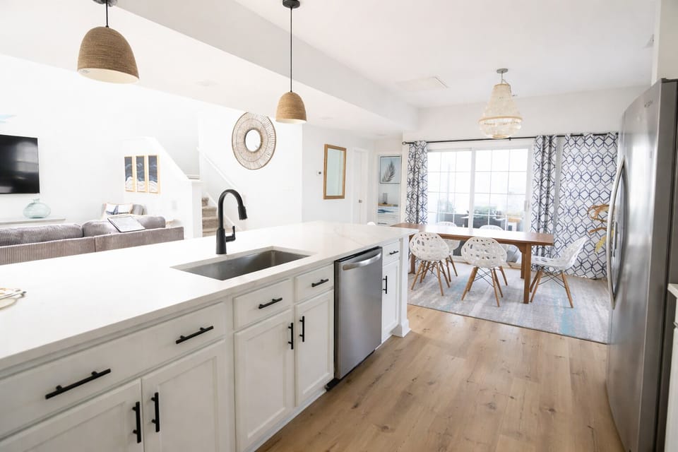 A bright open kitchen that keeps the cook in the conversation so no one gets left out