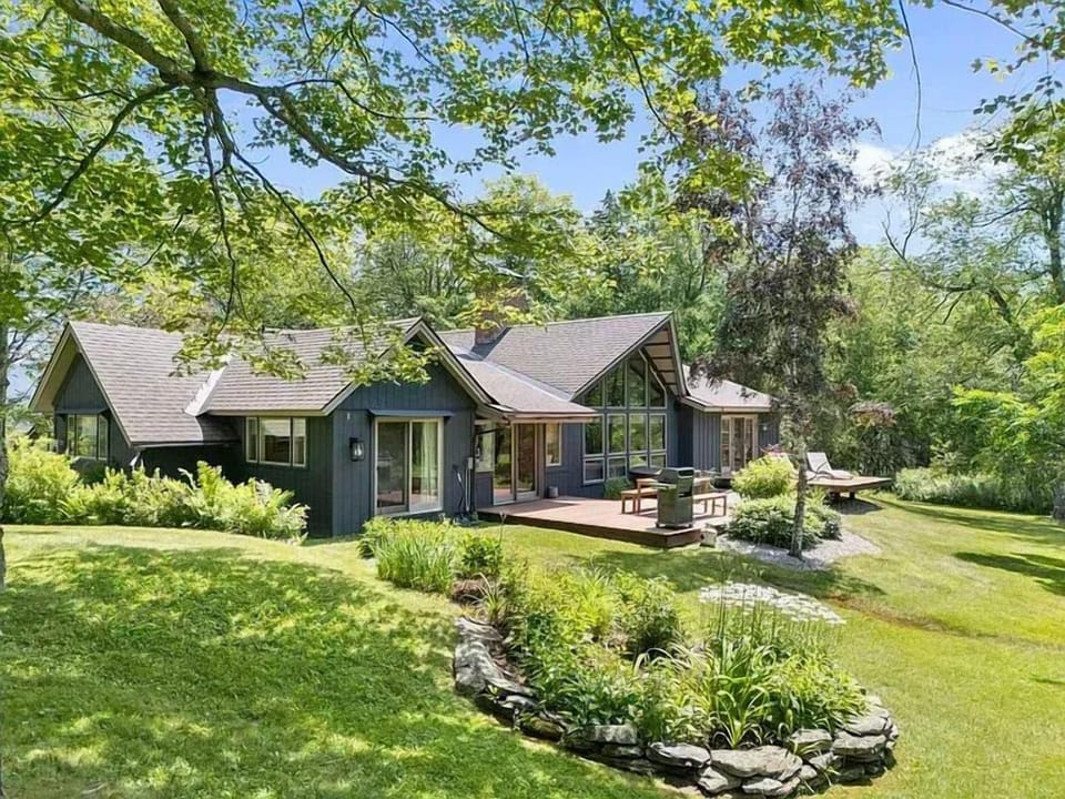 Exterior view — a modern mountain retreat surrounded by lush Vermont landscape and expansive grounds