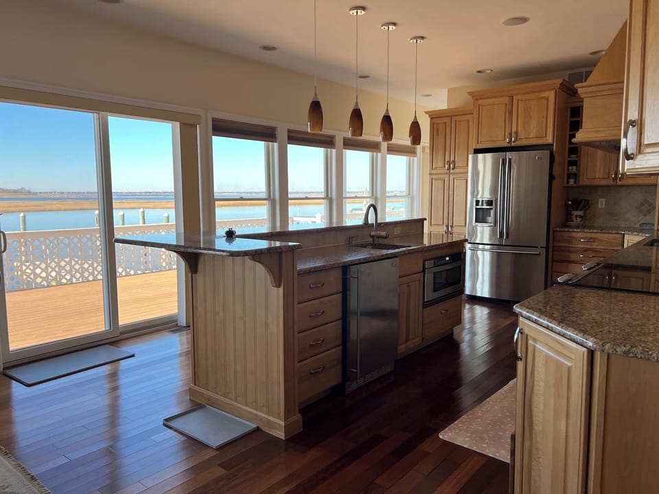 2nd prep sink, wine fridge and more bay views from the kitchen island.